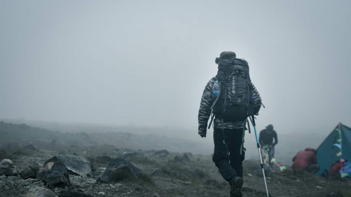 Adventurer backpacking in Foggy Mountain Landscape