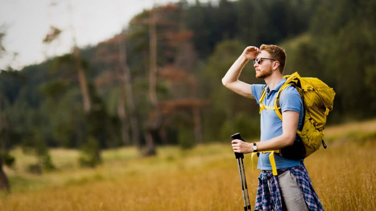 Young man enjoys hiking on a sunny day